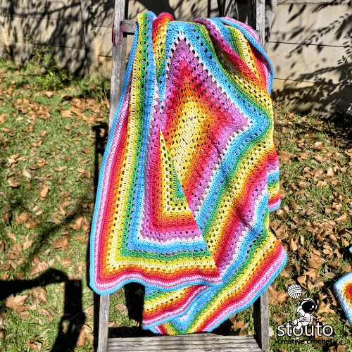 Soft rainbow striped crochet baby afghan with smooth texture