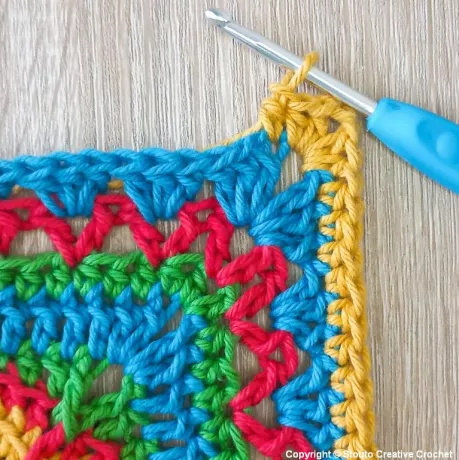 Round 11 of African flower crochet square increasing size and definition
