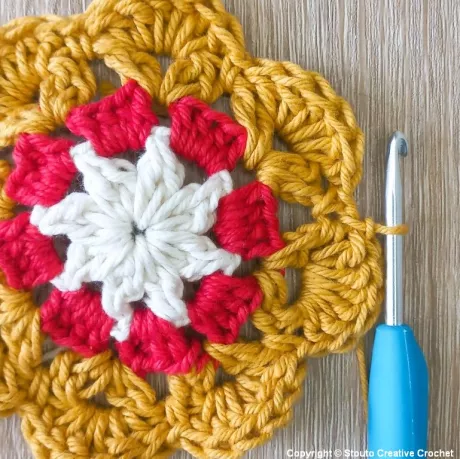 Round 4 of African flower crochet square adding raised petal texture