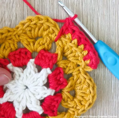 Round 5 of African flower crochet square working stitches in the back loop