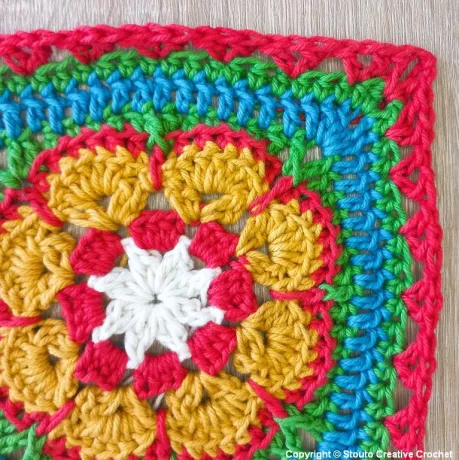 Round 9 of African flower crochet square with decorative v stitch details