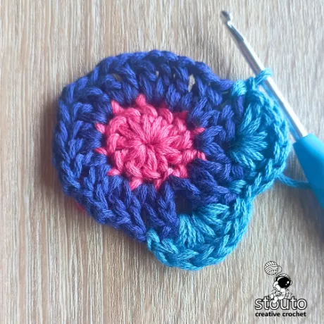 Petal base forming in round 3 of the Bold Buttercup flower crochet square