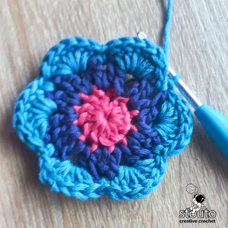 Completing round 3 of the Bold Buttercup flower crochet square