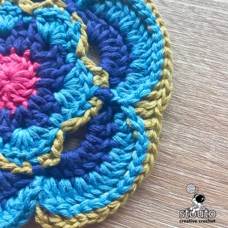 Textured post stitch ring in round 7 of the Bold Buttercup flower square