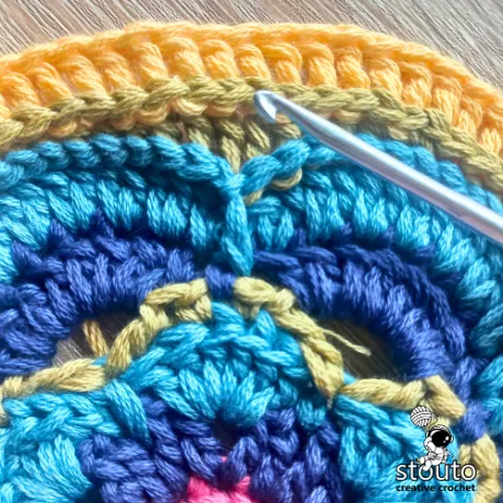 Back post stitches forming structure in round 8 of the flower crochet square