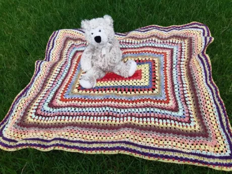 Crochet baby blanket made from scrap yarn