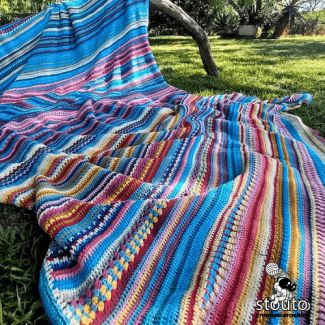 365 day crochet blanket showing daily temperature rows in colorful yarn