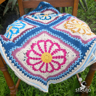 Three dimensional daisy crochet square with vibrant floral center