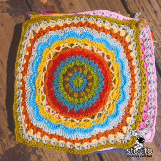 Large African flower crochet square pattern used as statement motif