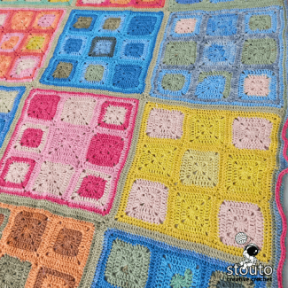 Beginner friendly granny square blanket with soft rainbow color palette