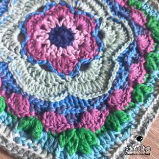 Bold Buttercup crochet square used as decorative cushion