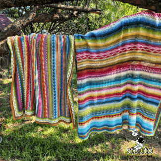 Crochet stitch sampler blanket styled as king size bedspread