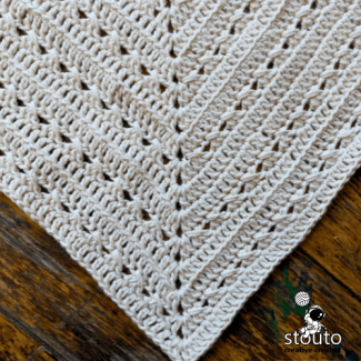 Close-up of crochet square blanket corner with 2 dc ch-2 2 dc increase