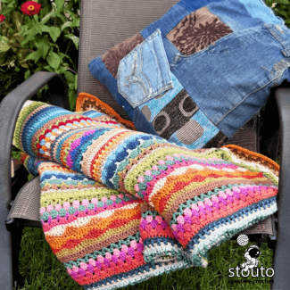Crochet stitch sampler blanket with colourful striped texture and mixed stitches