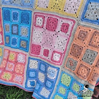 Easy crochet patchwork blanket created with simple granny squares