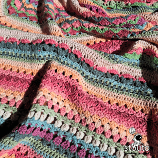 Flower garden crochet blanket pattern combining decorative floral stitches
