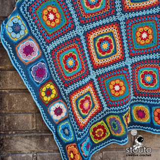 Modern African flowers squares blanket draped over couch