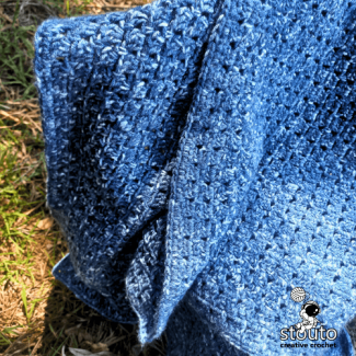 Modern granny square style crochet blanket using block stitch