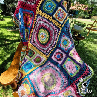 Patchwork crochet afghan design with vibrant flower squares