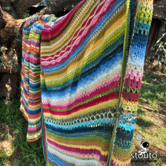 Striped crochet blanket with rich texture and varied stitches