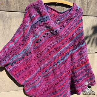 Textured stitches create a warm fabric while crochet poncho stays breathable and lightweight