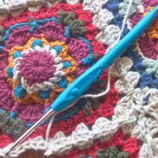 Finished African Cosmos crochet square ready for blanket or cushion project