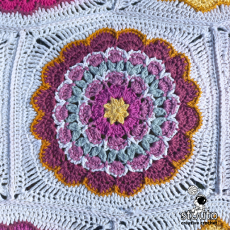 Granny square crochet pattern with decorative stitch texture