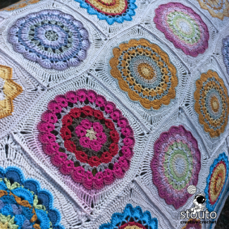 Yarn and crochet supplies for making a granny square blanket pattern