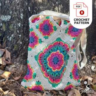 Crochet flower granny squares arranged before joining into a tote bag