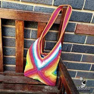 Front view of an easy crochet granny square tote bag made with colourful textured crochet squares.