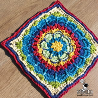 Fiorone flower granny squares arranged for a crochet blanket
