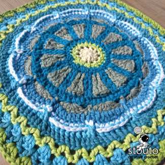 Textured TMBJGF Flower Granny Square featuring layered crochet flower petals and post stitches.