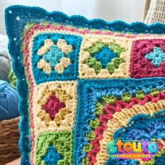 Colourful Flower and Squares crochet pillow front with floral centre and patchwork border