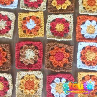 Colourful crochet flower granny squares made in different yarn colours 