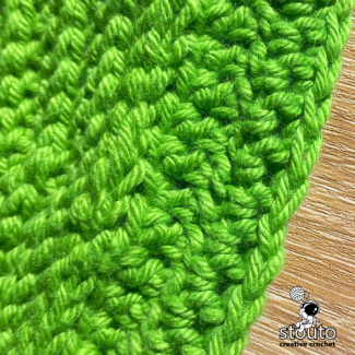 Crochet round bag back panel worked in textured front post double crochet stitche