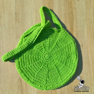 Crochet round bag back panel worked in textured front post double crochet stitche