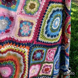 Fancy but easy crochet stitches makes a textured  crochet blanket