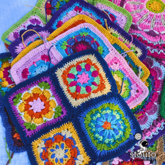 Detailed texture of flower crochet motifs in mixed yarn colours