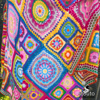 Handmade floral granny square blanket showcasing colourful crochet flowers