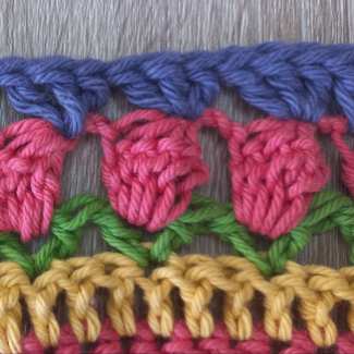 Row 56 : Work into the top of the popcorn stitch only.