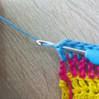 finish off yarn tail of crochet blanket row