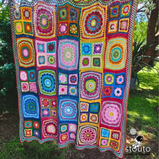 Patchwork flower crochet afghan shown in lapghan size example