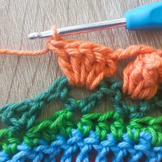 Work 5 dc stitches in ch-sp, remove hook from work,
