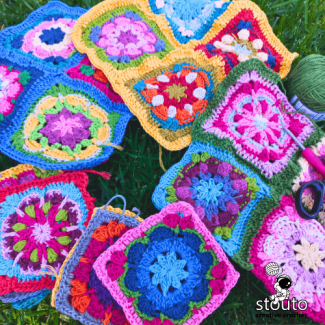Close-up of vibrant African flower crochet squares in bright yarn colors