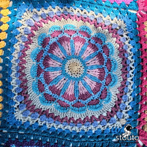 African patchwork crochet flower square showing bold color contrast and petal detail