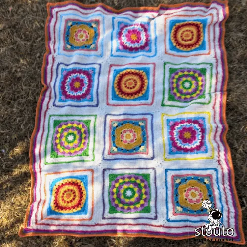 Four large crochet flower squares in the Boxed Flower blanket design