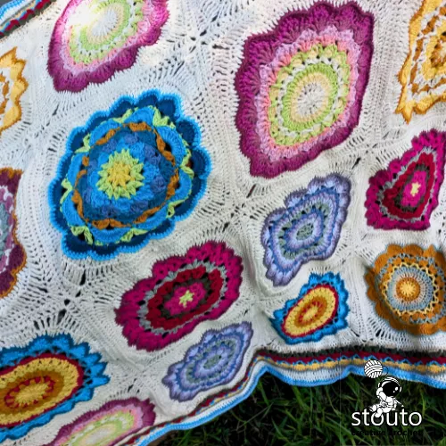 Colourful African bouquet afghan made from floral granny squares