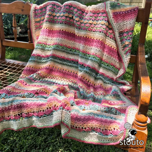 Crochet sampler blanket showcasing different flower stitches and textures