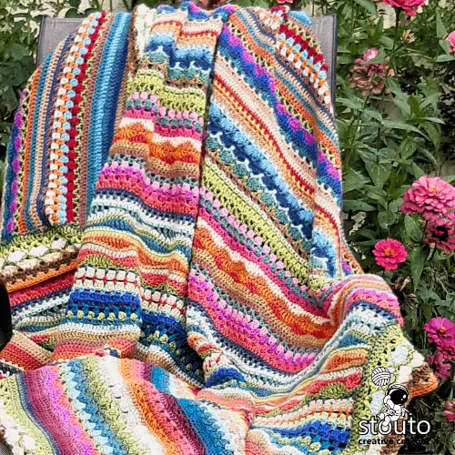 Crochet stitch sampler blanket created with bold and vibrant yarn colours