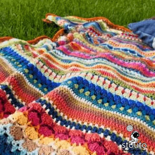 Crochet stitch sampler blanket demonstrating yarn fibre and colour selection